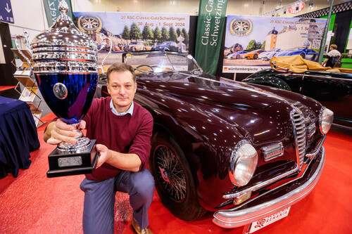 Alfred Bauer, Managing Director of Scuderia Renania, with the trophy for the most beautiful classic car at the Essen Motor Show, an Alfa Romeo 6C 2500 SS Cabriolet Pininfarina from 1949.